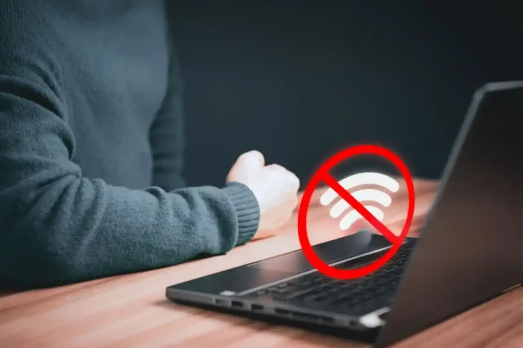 Laptop showing a no Wi-Fi connection symbol