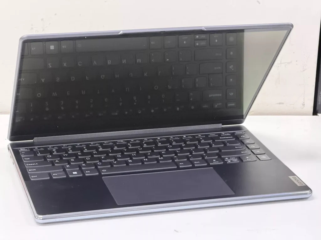 Fully repaired Lenovo laptop sitting open on a clean surface during post-repair quality assurance testing.