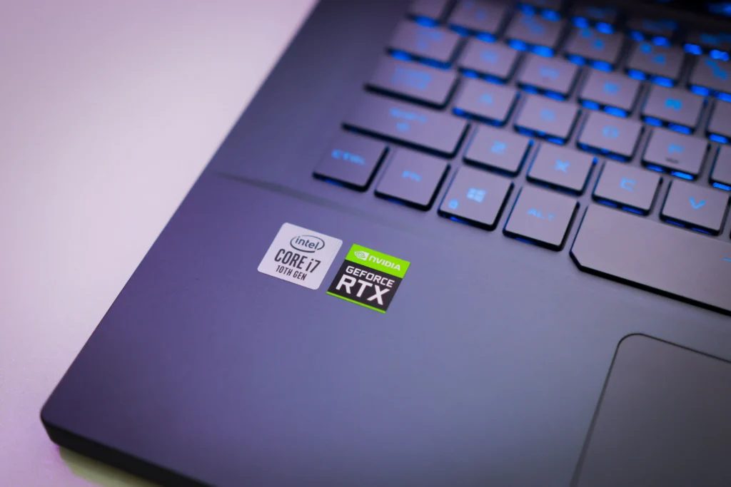 Close-up view of a modern laptop keyboard and palm rest featuring Intel Core i7 and NVIDIA GeForce RTX processor and graphics hardware labels.